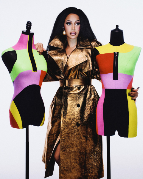 Portrait of Cardi B in gold coat next to two colorful mannequins